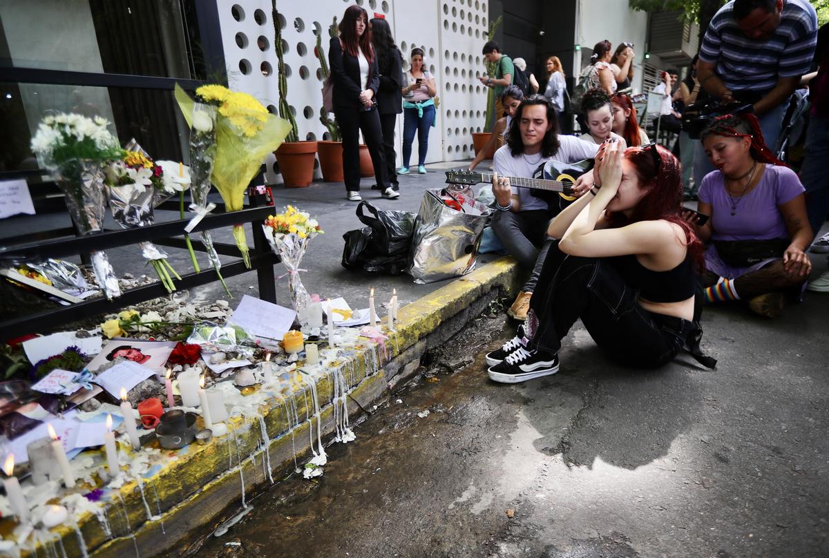 Fans mourn at a memorial in tribute to former One Direction singer Liam Payne after his death outside Casa Sur Hotel on October 17, 2024 in Buenos Aires, Argentina.