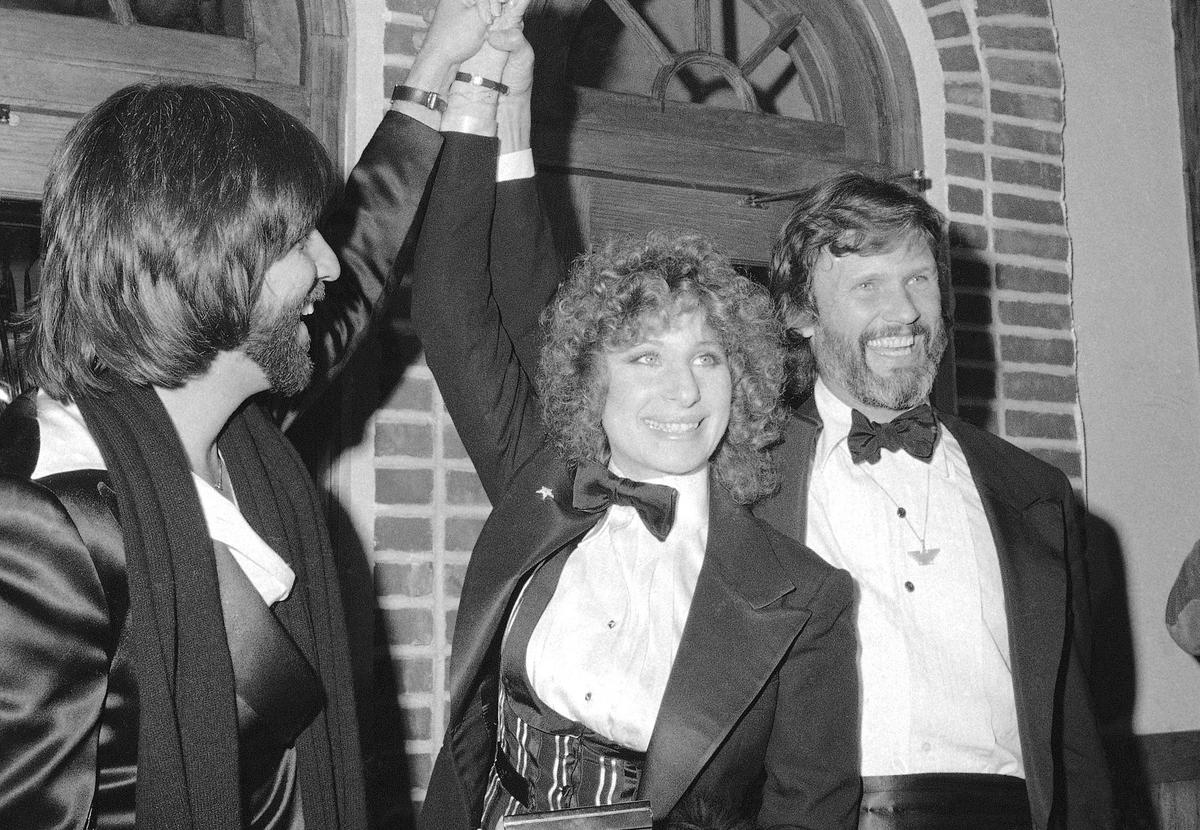 FILE - Producer Jon Peters, from left, Barbra Streisand and Kris Kristofferson appear at a preview of the film, “A Star is Born,” in Dec. 23, 1976, in New York.