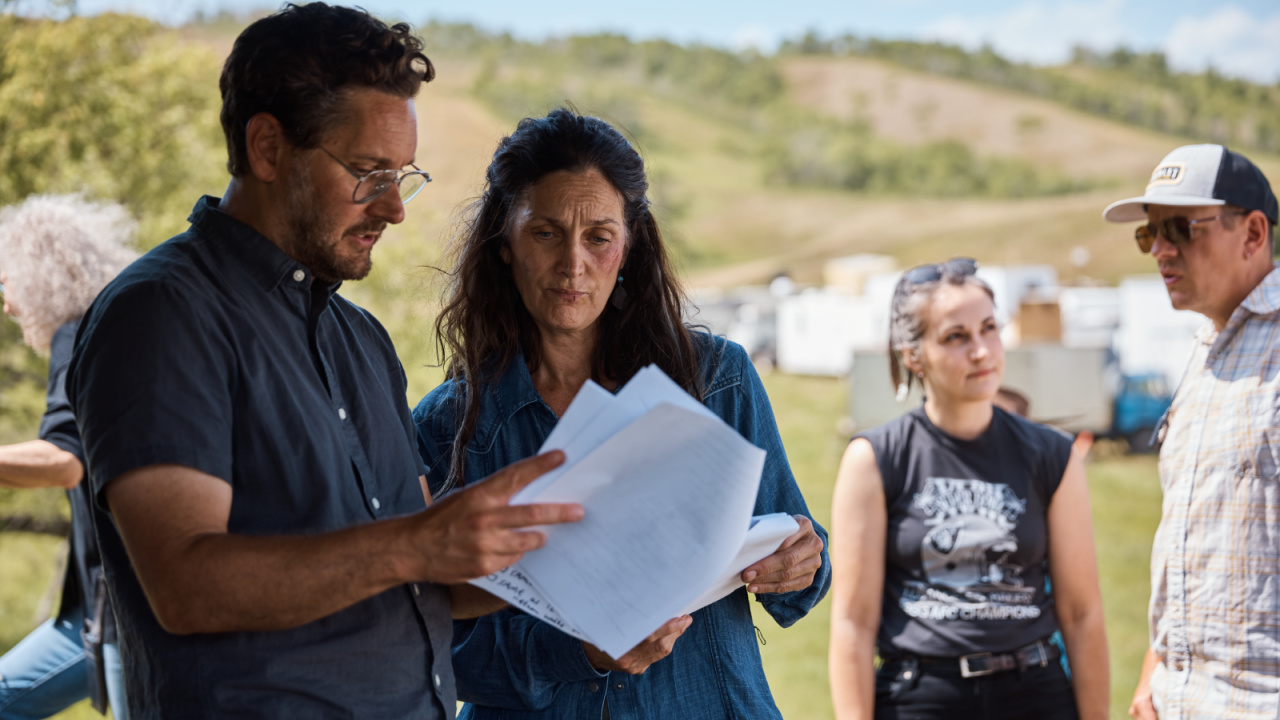 (L to R) Carrie-Anne Moss as Mae and Director Lowell Dean in a BTS still from the Thriller, Horror 'Die Alone', a Quiver Distribution release. Photo courtesy of Quiver Distribution.