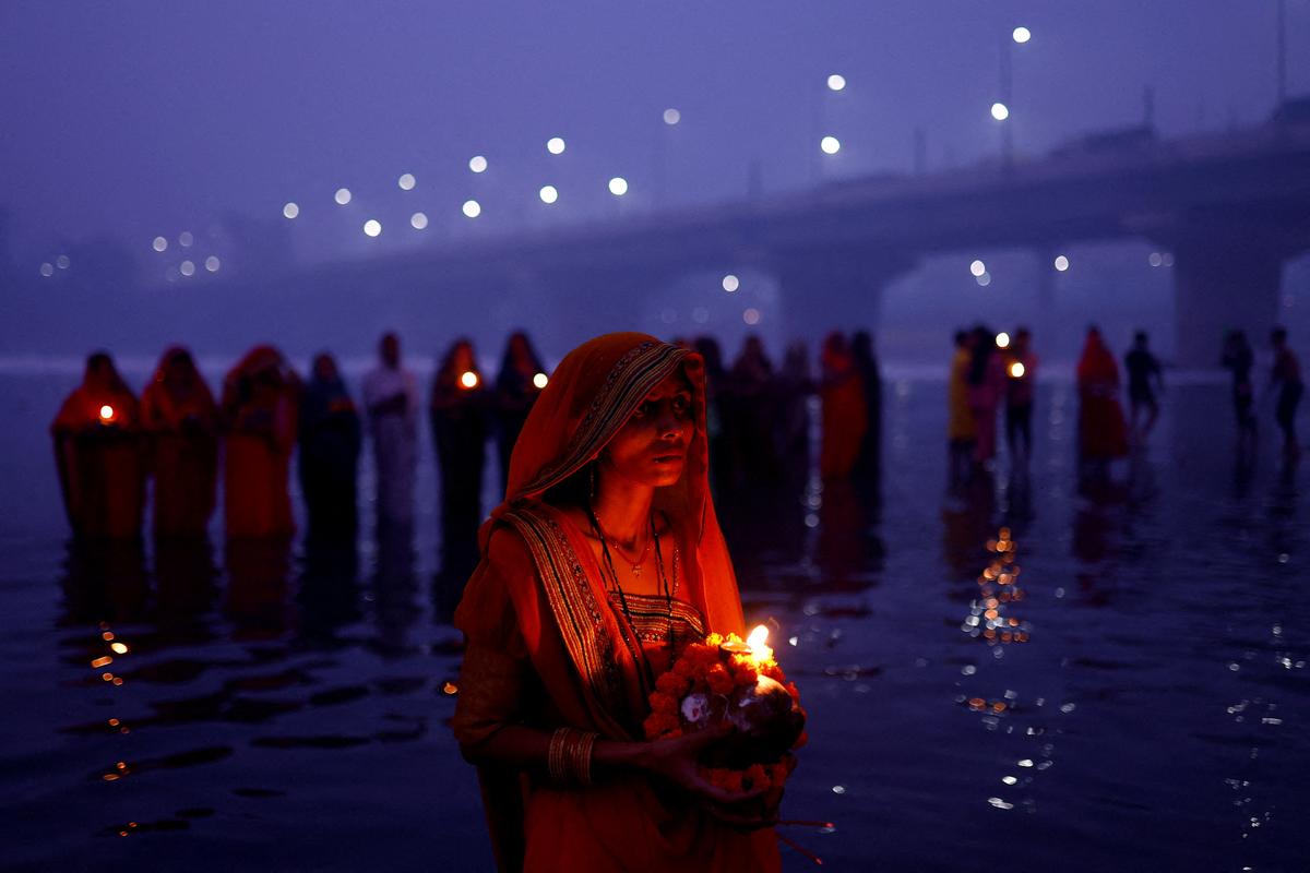 Women performing rituals during the Chhath Puja.      